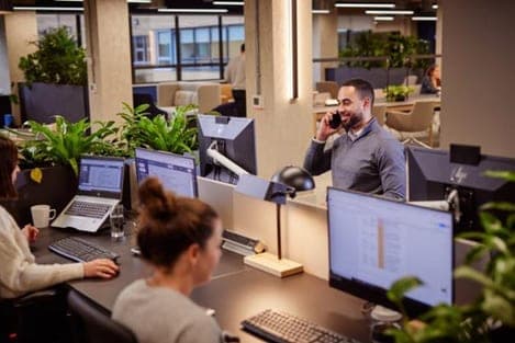 Colleagues at work across the office floor
